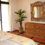 bedroom with ornate mirror