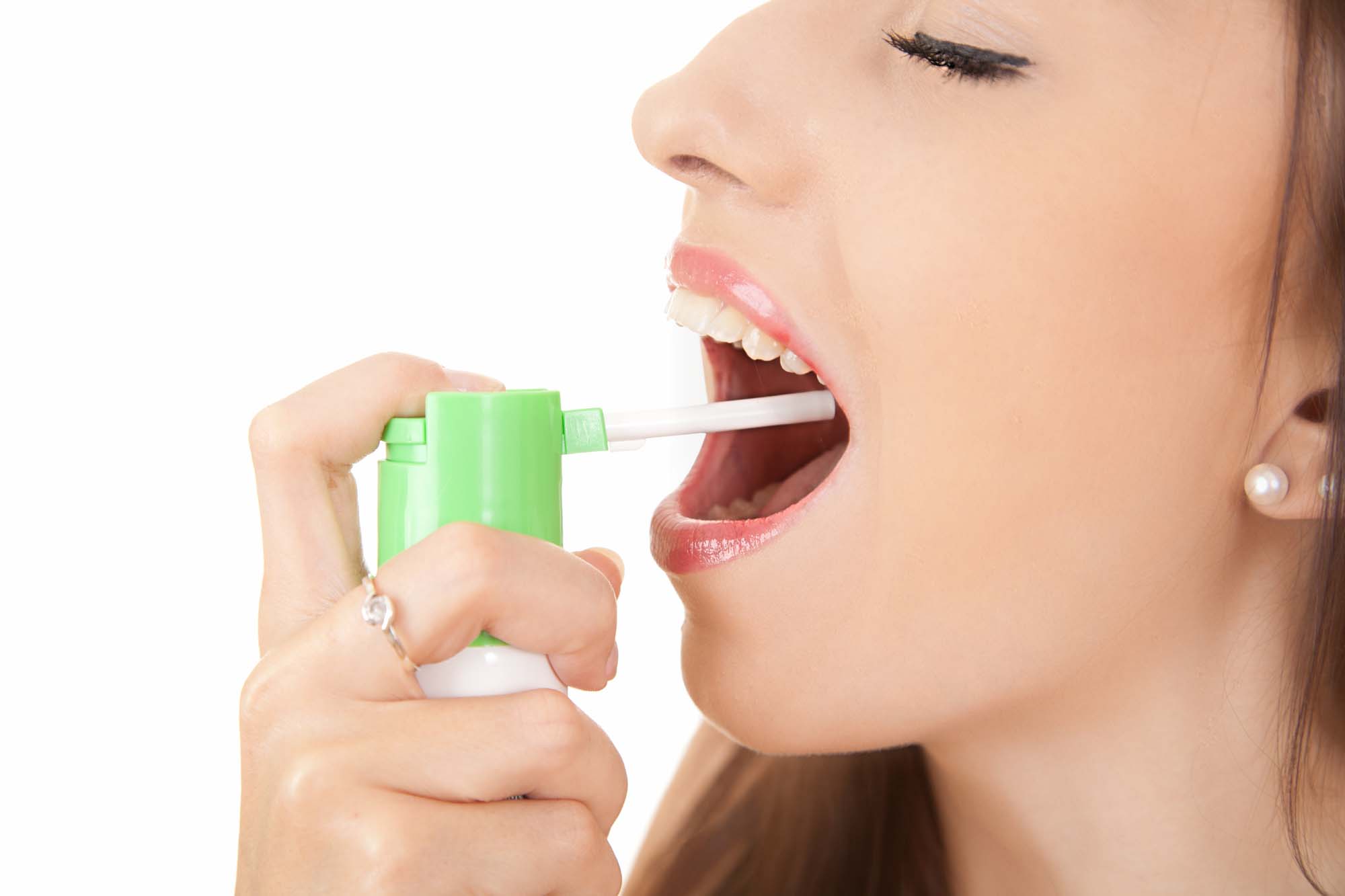 suffering from pain, young woman using throat spray, white background