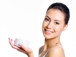 Woman holding moisturizing facial cream