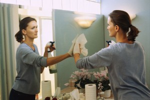 Woman Cleaning Mirror