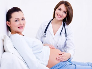 Doctor touches the belly's pregnant