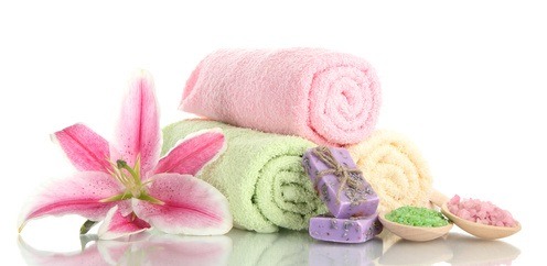 towels with beautiful pink lily, aroma oil and sea salt