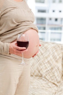 Pregnamt woman with a glass of wine
