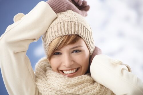 Portrait of happy young woman in warm coat