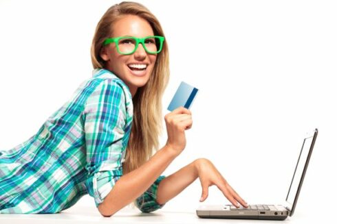 Young Woman Sitting at the desk shopping Online on white