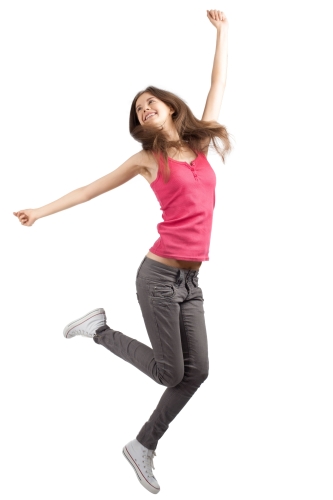 Full length studio shot of happy young woman jumping with arms extended . Over white background