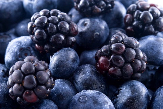 Close up of blueberries and blackberries in a pile