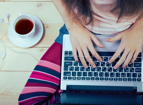 Teen girl sitting with a laptop