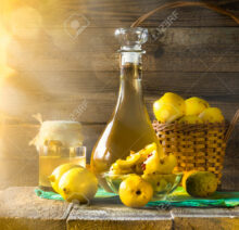Tincture of quince and fruit on a wooden table