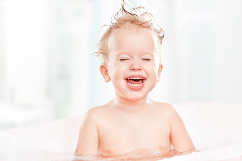happy funny baby laughing and bathed in the bath