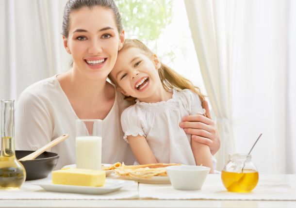 mother and daughter prepare pancakes