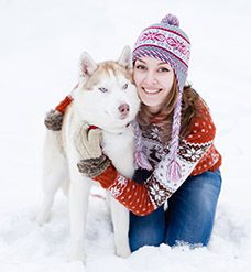 Young woman with dog winter outdoors fun