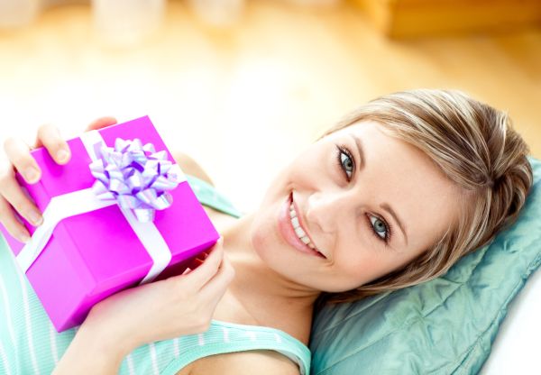 Smiling woman holding a present