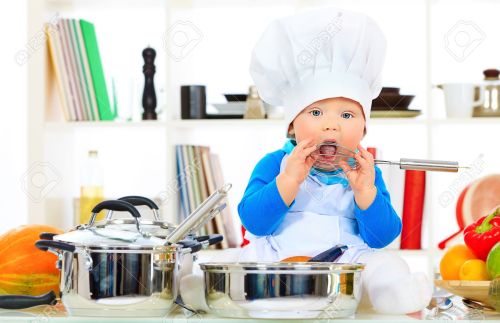 21199130-Cute-small-baby-in-the-cook-costume-at-the-kitchen--Stock-Photo
