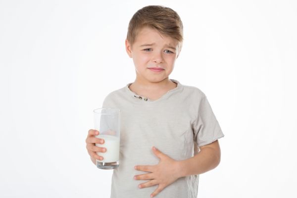 child with painful expression after drinking milk