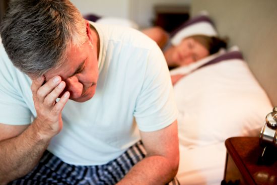 Man Awake In Bed Suffering With Insomnia